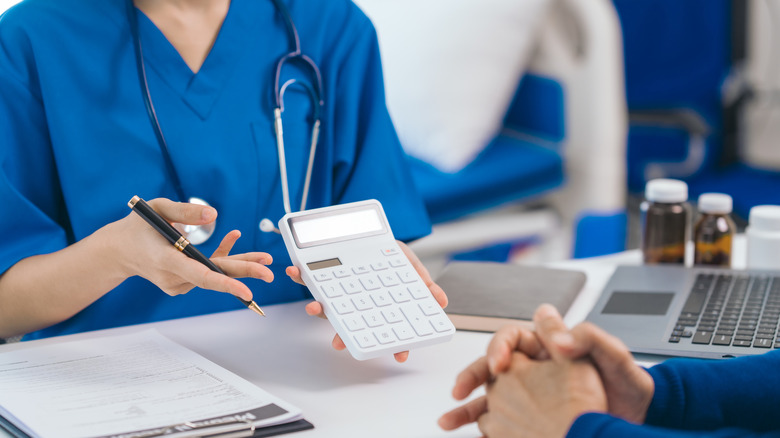 medical professional showing patient cost result