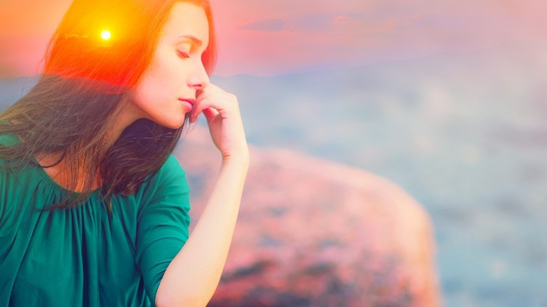 woman sitting with eyes closed