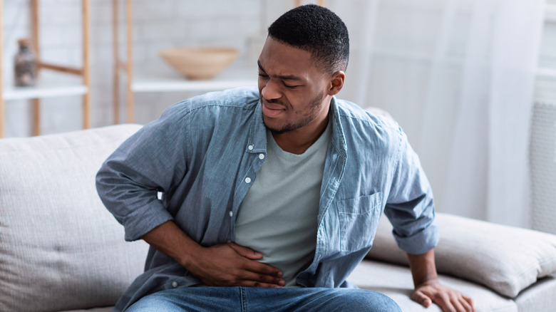 Man holding stomach in pain