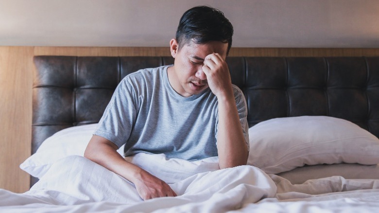 man dizzy in bed