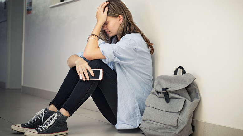 depressed girl sitting on floor