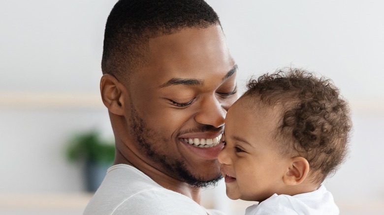 Close up father holding baby