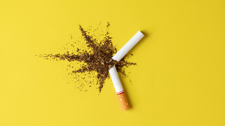 broken cigarette on yellow background