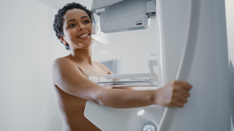 smiling woman getting mammogram