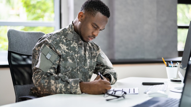 soldier completing paperwork