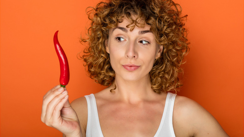 woman holding hot pepper