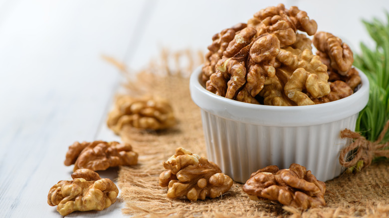 Pair of heart-shaped hands holding walnuts