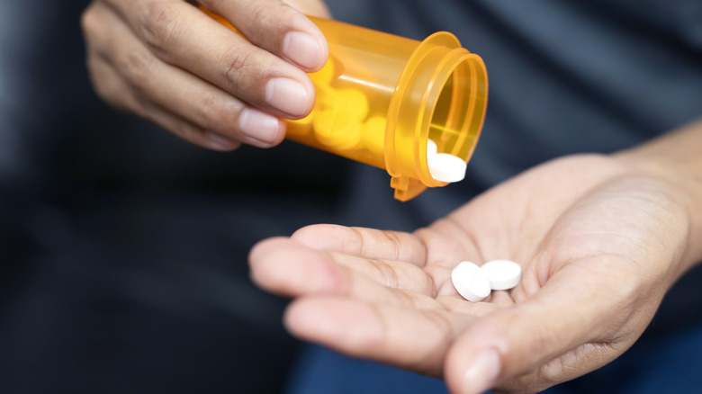 Pills being poured into hand