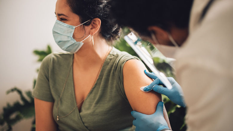 Masked woman getting vaccine