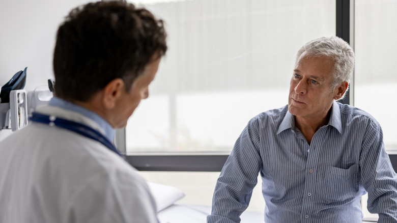 man talking to doctor