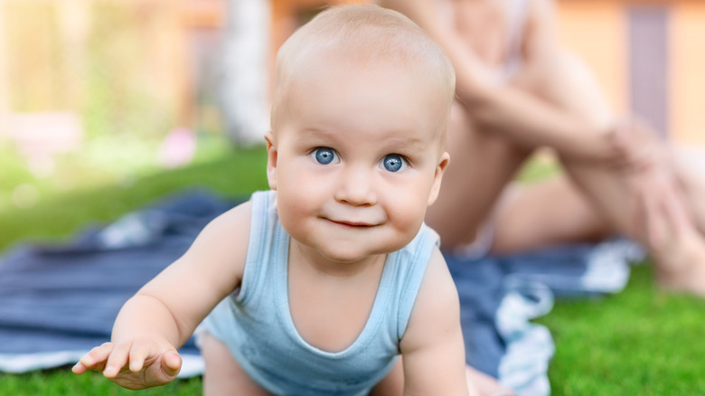 baby crawling on grass