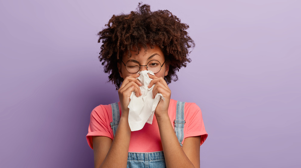 woman blowing nose