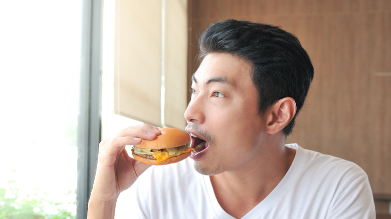 man eating burger