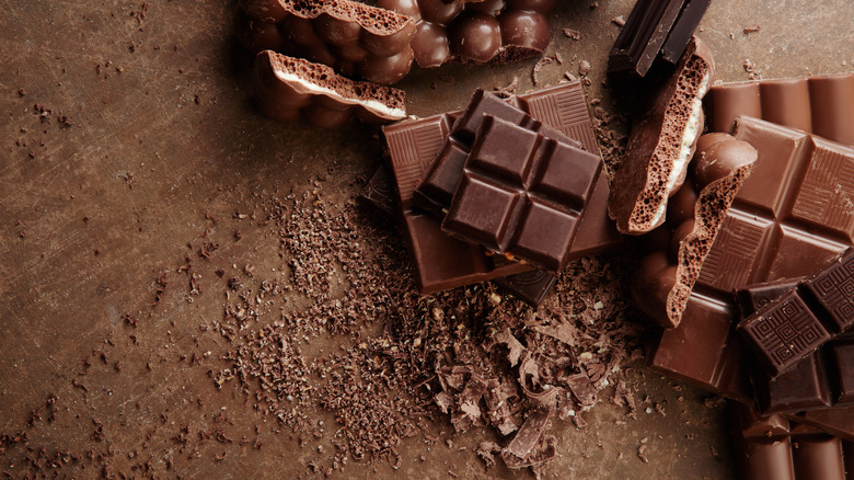 Several types of chocolate sits on a brown table