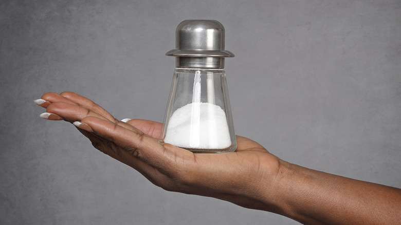woman holding salt shaker