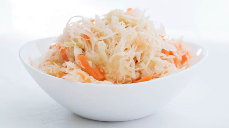 Cabbage and carrot sauerkraut on a white plate