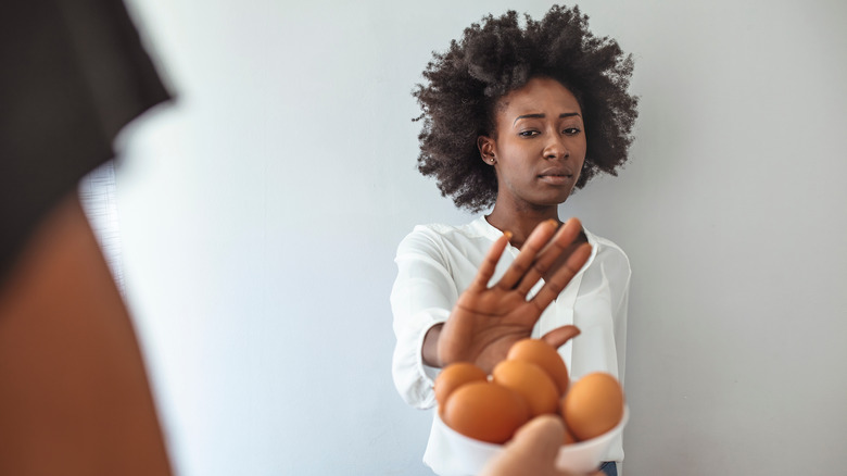 Woman refusing eggs
