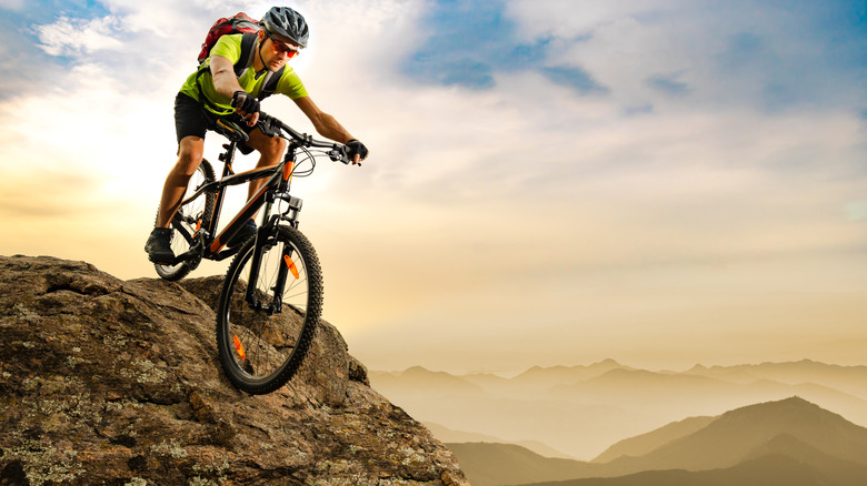 man bicycling down mountain