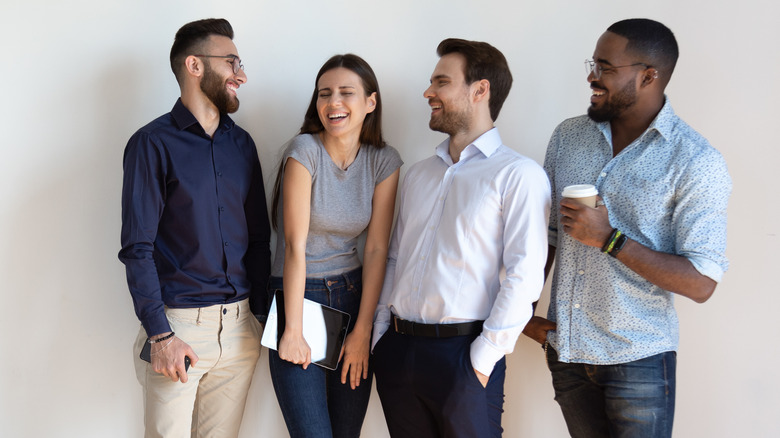 Four people laughing together