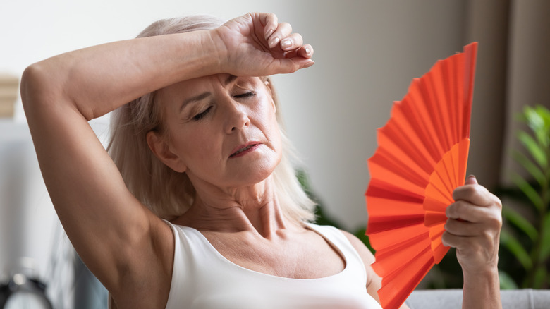 Woman fanning herself 