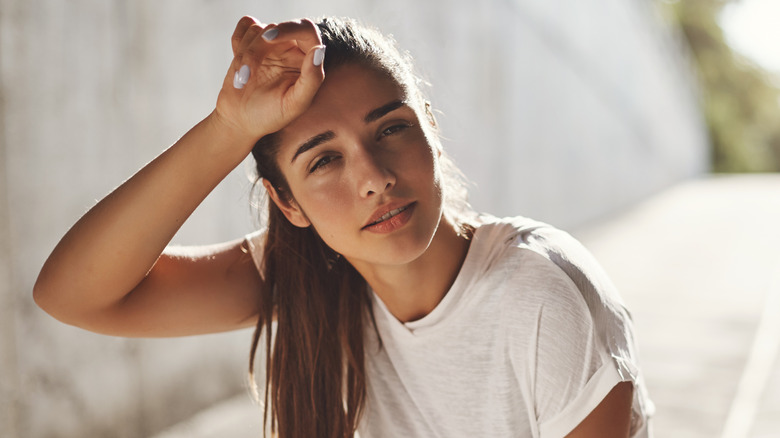 A woman looks winded while on a run/walk