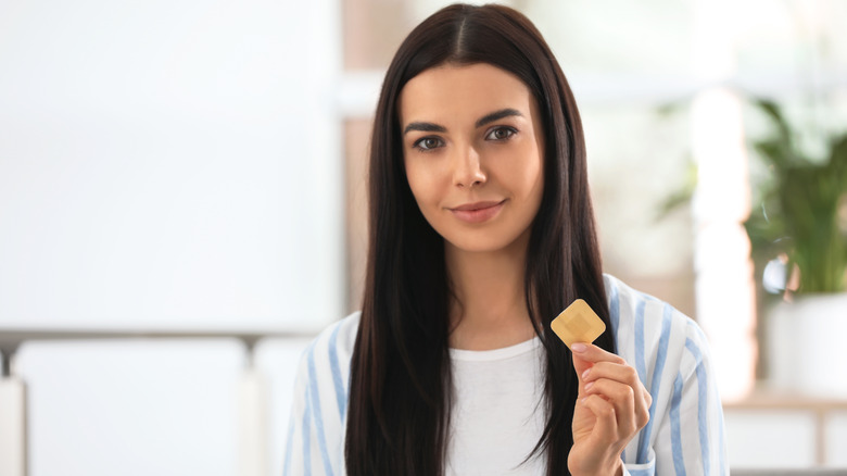 Woman holding a nicotine patch in her hand