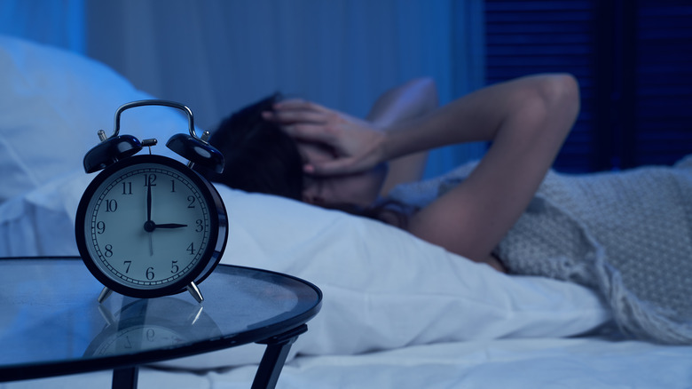 Woman struggling to fall asleep 