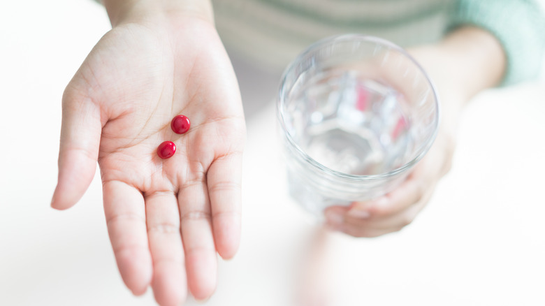 woman taking iron supplement