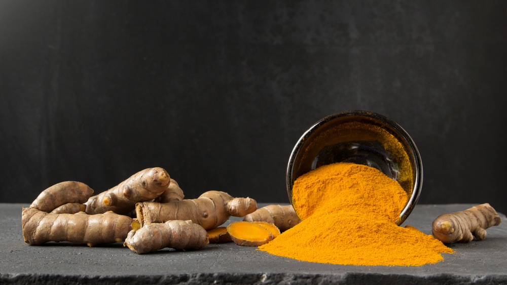 Turmeric spilling out of a cup