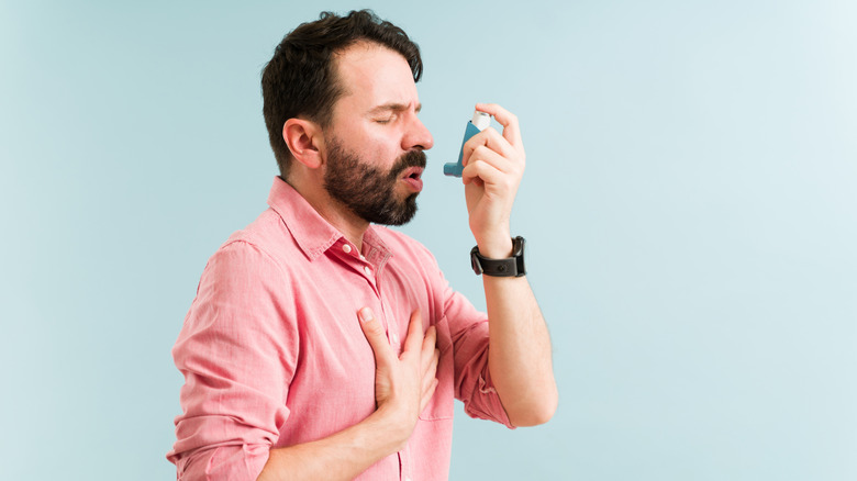 Man using an inhaler