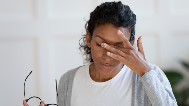 Woman rubbing eyes