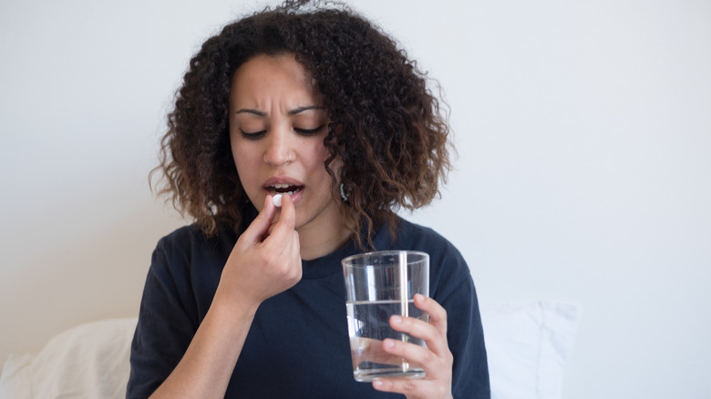 woman taking medication