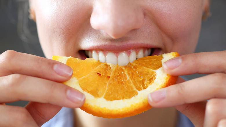 woman eating an orange