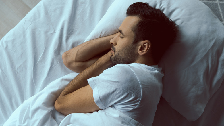 Man lying on his side in bed