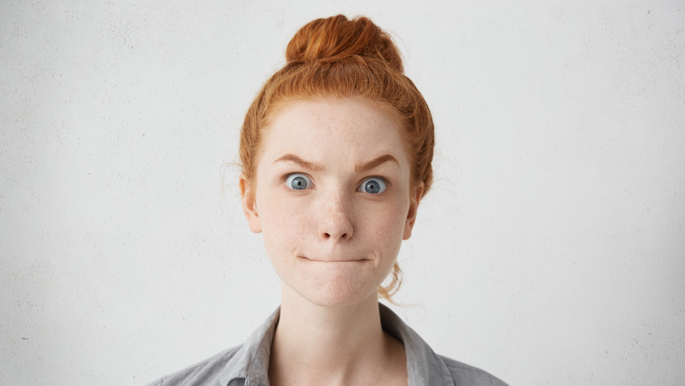 Redheaded woman looking surprised