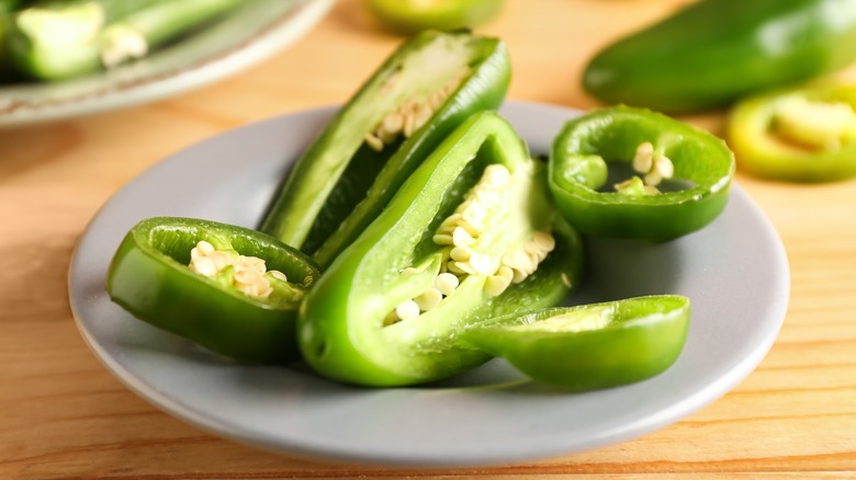 Green jalapeños on a white plate