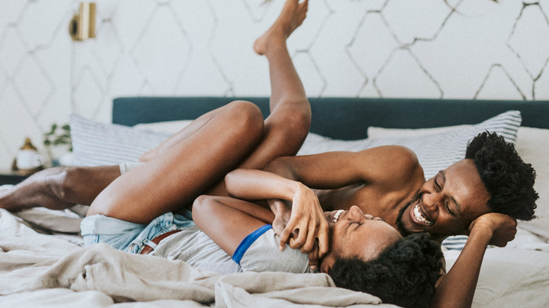 Playful couple in bed