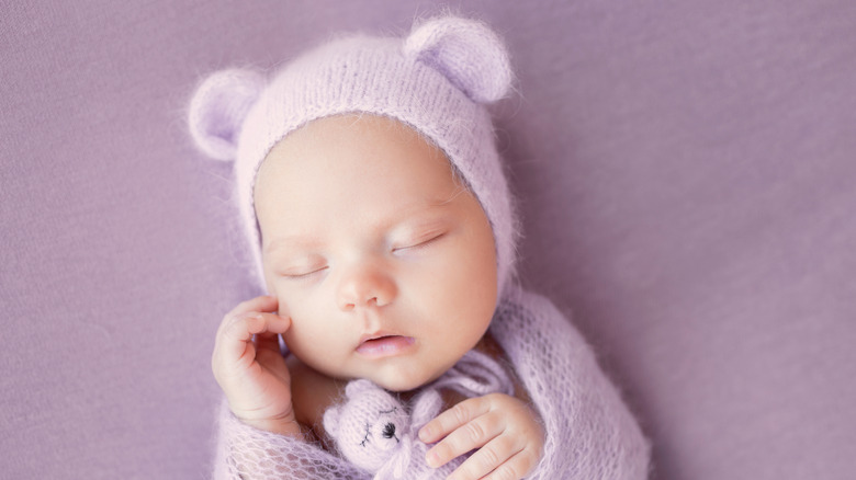 Sleeping baby in cap with ears