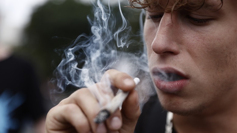 Young man smoking marijuana