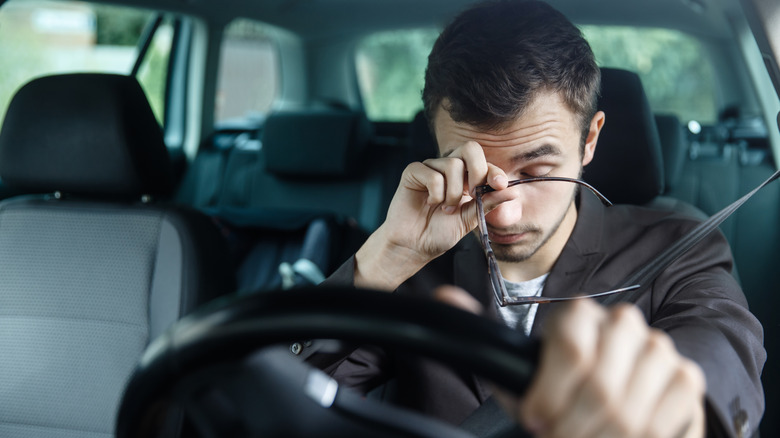 Tired man driving car