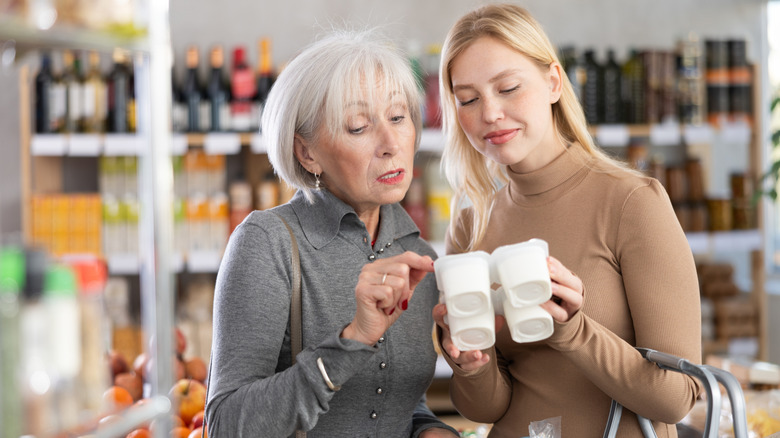 older woman and younger woman looking at yogurt