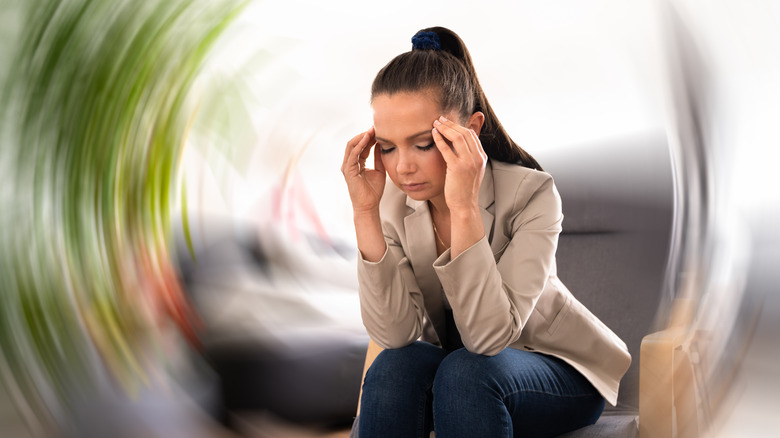 Woman with headache and vertigo