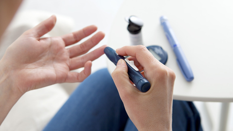 Woman using glucometer