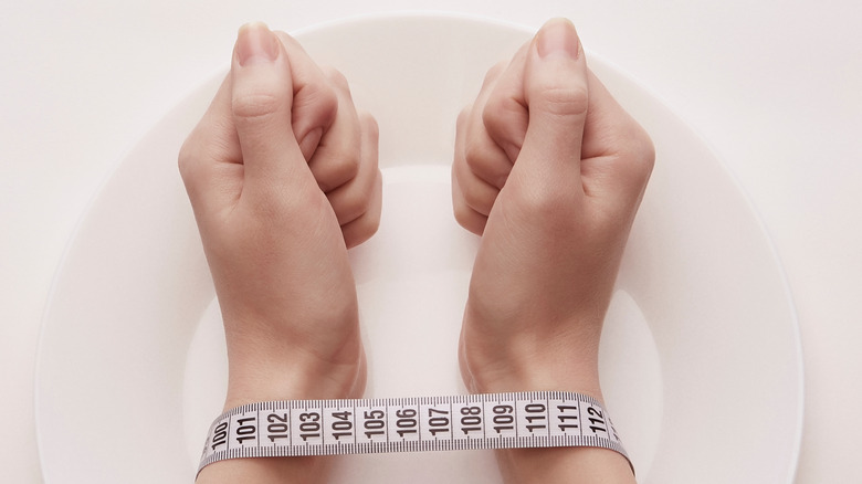 taped hands on an empty plate
