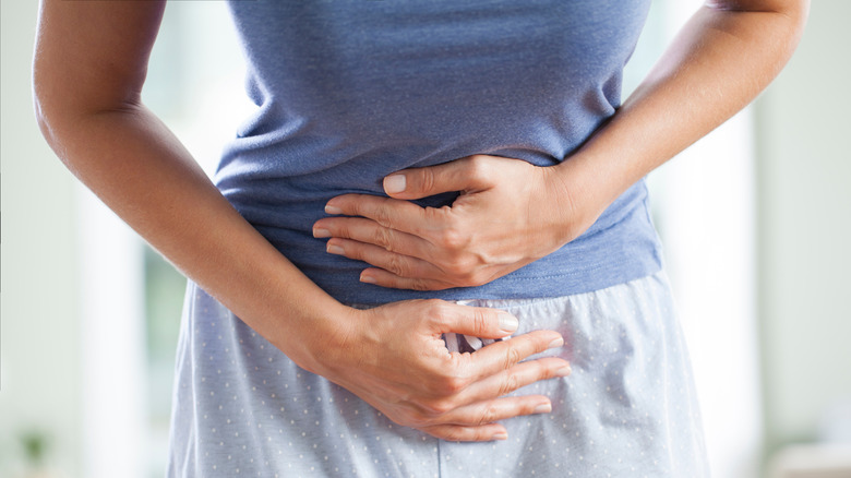 Woman holding her abdomen in pain