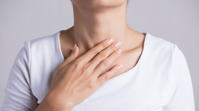 woman touching neck