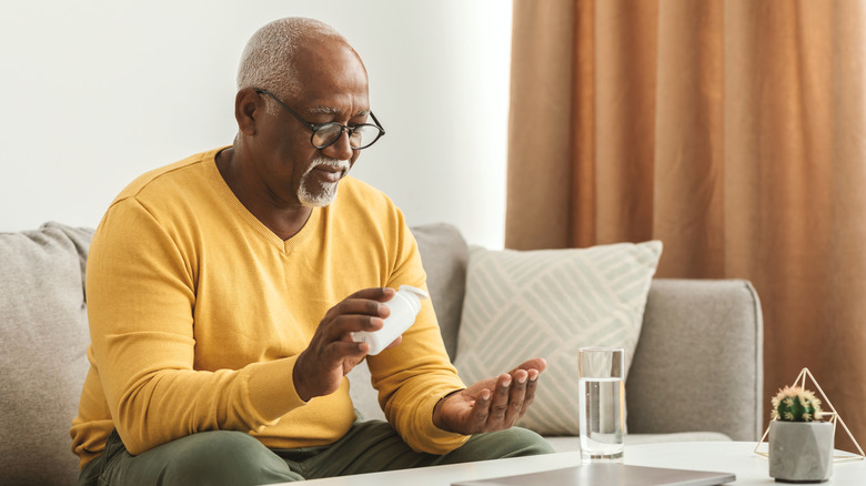man preparing to take his medication