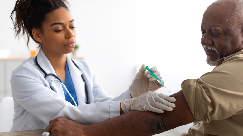 doctor injecting patient with tetanus shot