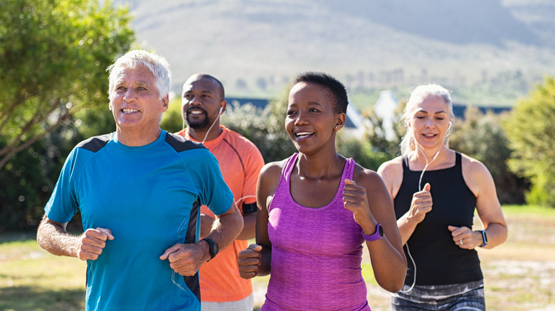 a group of diverse older adults running outdoors