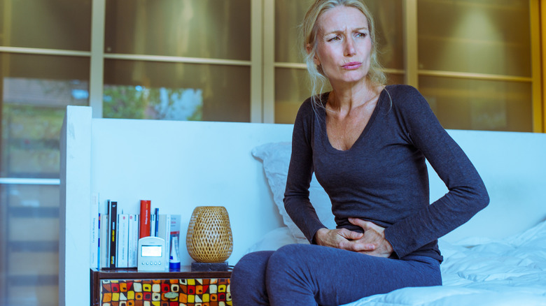 Woman holding her stomach in discomfort